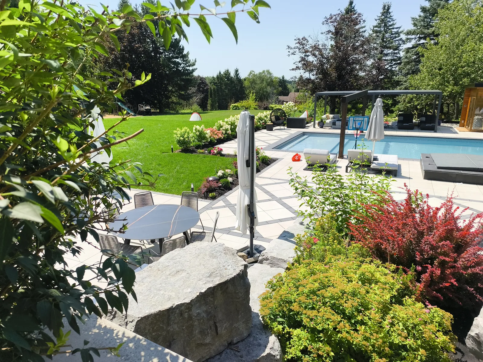 Planted garden and stone patio leading down to the pool