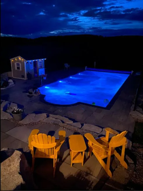 Pool and fire pit lit at night