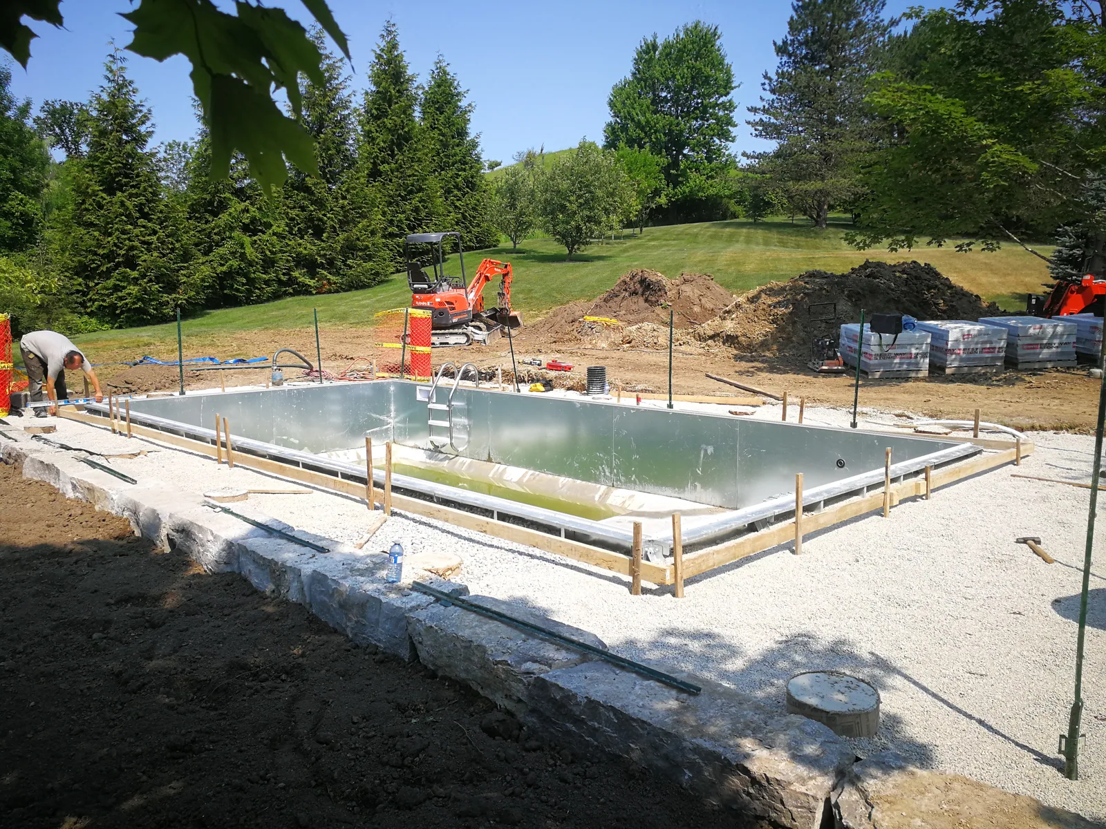 Part filled pool shell with the excavator still on site